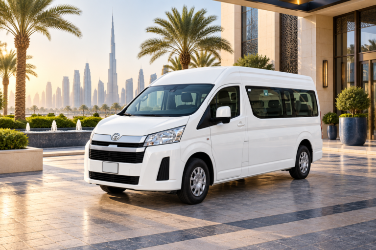 White Toyota Hiace van at a Dubai hotel forecourt with the skyline behind it