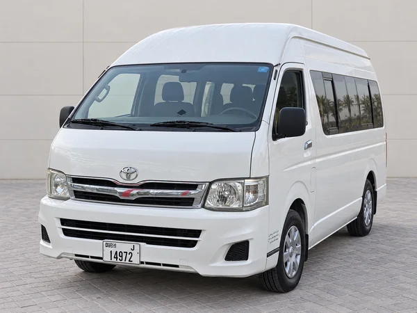 White high-roof Toyota Hiace 15-seater minibus
