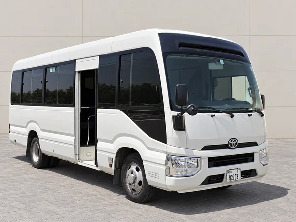 White Toyota Coaster 22-seater minibus