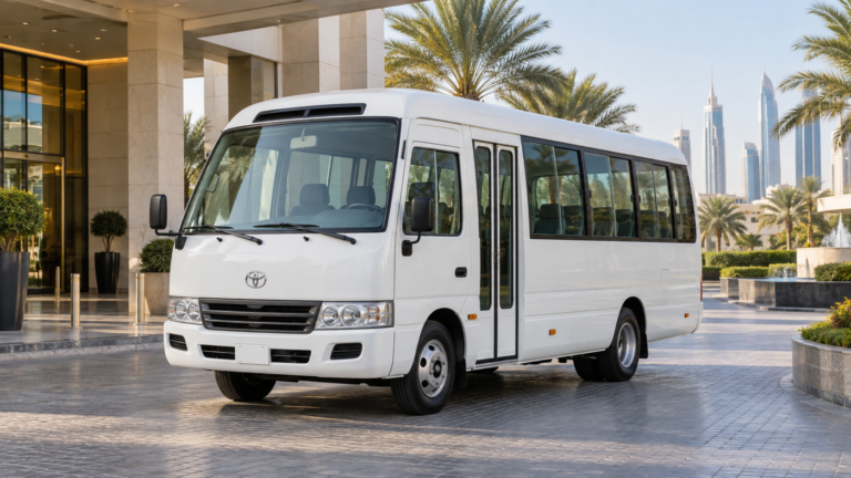 Coaster bus rental in Dubai – illustration of a white Toyota Coaster outside a hotel