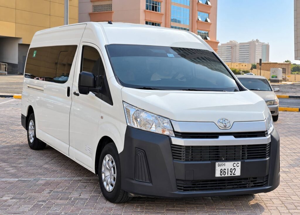 White Toyota Hiace passenger van viewed from the front and side