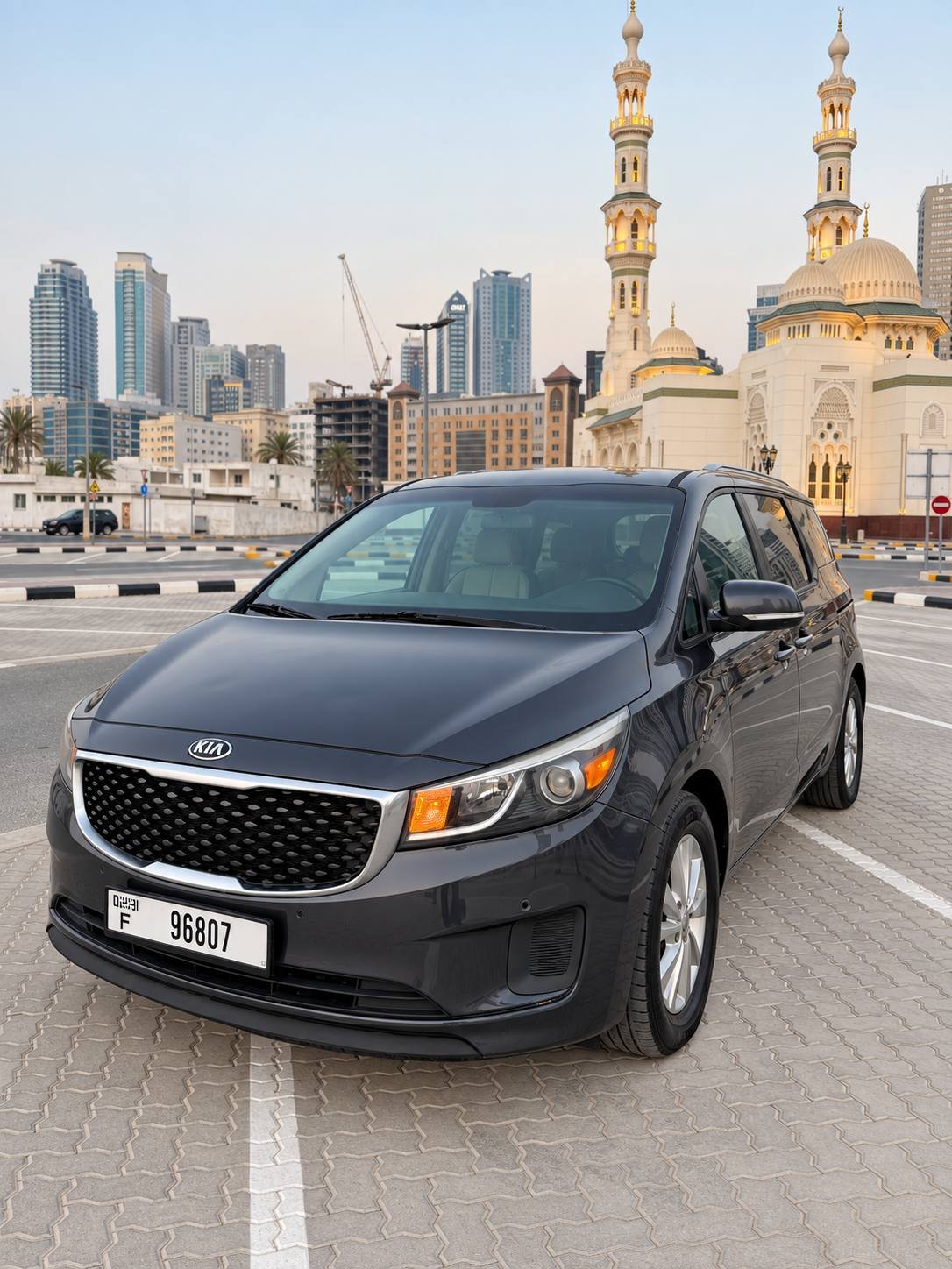 Dark grey Kia Sedona front three-quarter view in Dubai